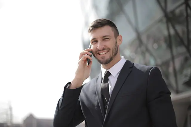 man-in-black-suit-jacket-holding-smartphone-3778680